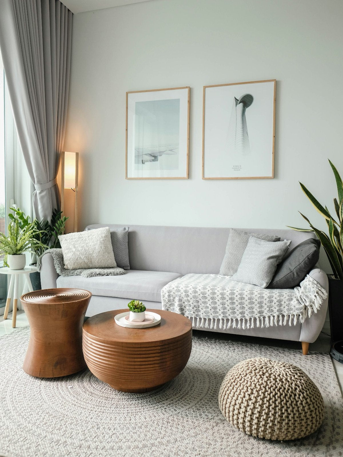 The minimalist-style living room features two framed artworks that enhance the decor on the wall.