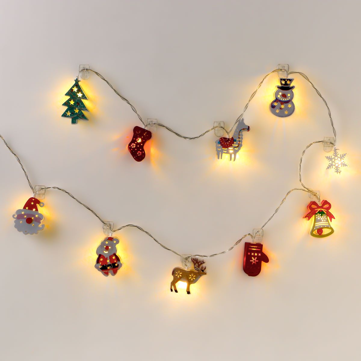 Two rows of Christmas lights decorated with mini clips, featuring Christmas trees, red stockings, red gloves, bells, reindeer, and Santa Claus.